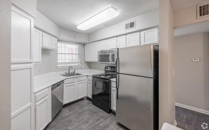a kitchen with white cabinets