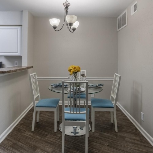 a kitchen with a dining table and chairs