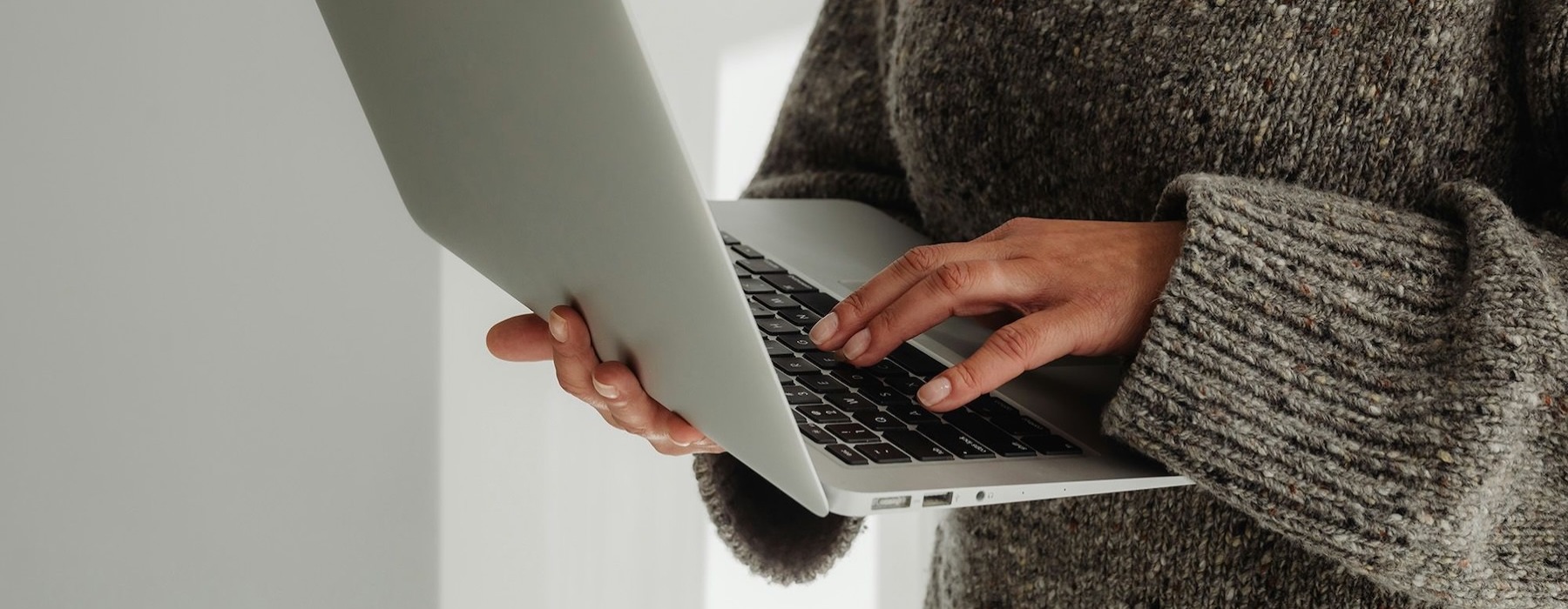 A person holding a laptop.